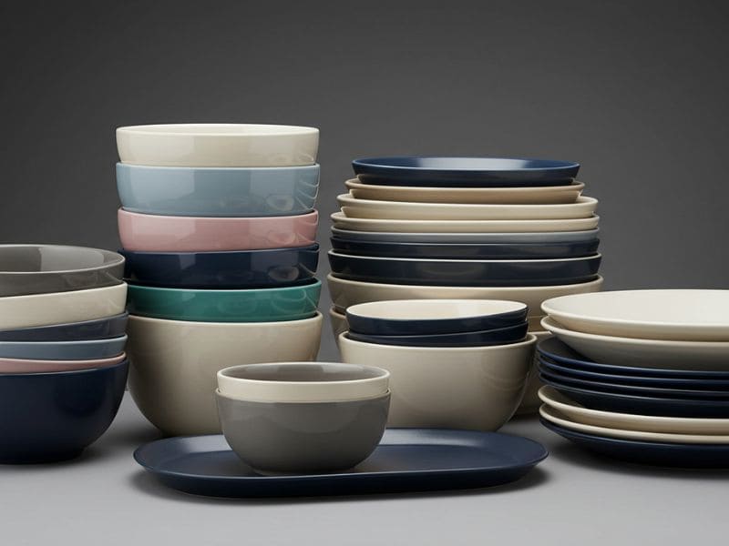 Color-blocked melamine bowls and plates in pastel tones for hotel buffet